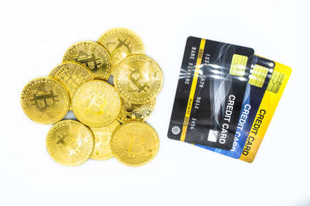 Group of golden Bitcoin and stack of credit cards isolated on white background. The symbol kind of modern currency.の写真素材