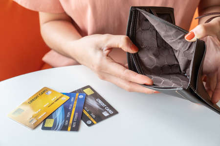 Close-up of woman hands open an empty wallet, Bad economics situation but she still have some credit...