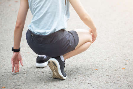 Cropped shot view of athlete runner woman in start position ready for sprint. Conceptual of sport and exercise workout.の写真素材