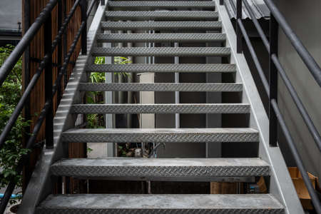 The metal stairway setting in office building using to escape from emergency such as fire or dangerous conditions. Emergency exits can be found in a number of places such as buildings, planes etc.の写真素材