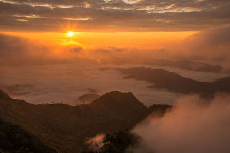 Beautiful sunrise over highland mountains view from Phu Chi Dao located in Chiang Rai province of Thailand. Winter landscape in Northern region of Thailand.の写真素材