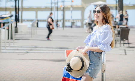 Portrait of happy Asian woman shopping in Napier the beautiful art deco town of Hawke's Bay region, New Zealand. Holiday concept.の写真素材