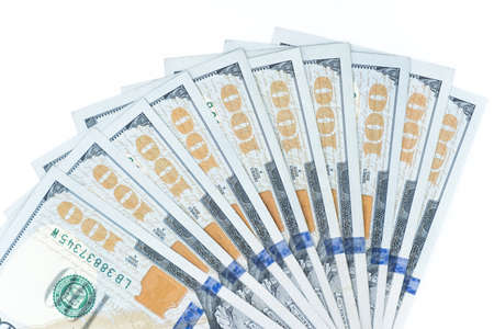 A fan of money. Close up of One hundred dollars banknotes on isolated white background. The official...