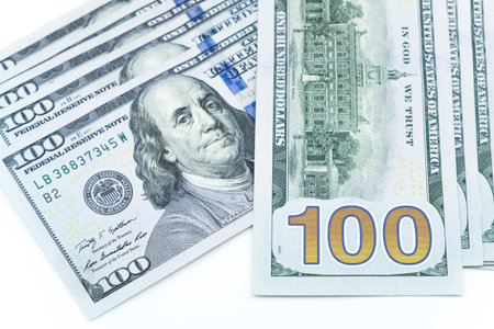 Close up shot of One hundred dollars banknotes on isolated white background. The official currency...