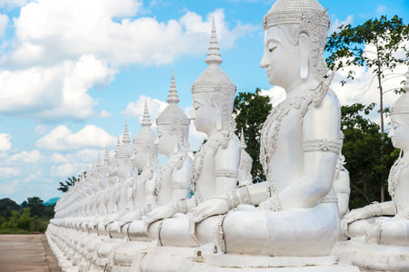 Cropped shot view of white Buddha statue sitting in a rows.の写真素材
