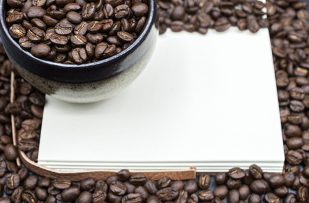 A book open the empty page with frame coffee beans background.の写真素材