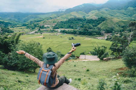 Happiness tourist woman looking to beautiful rice paddy field in Sapan village a small village nestled in a forested northern valley of pure air and pristine rivers in Nan provinceの写真素材