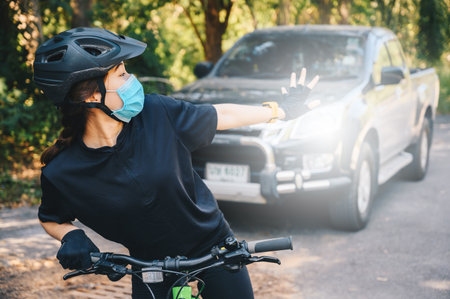 Cyclist woman sacred while a truck driving behind her bike. Cycling injuries are an unfortunate part...