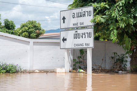 Chiang Rai, Thailand : 12-September-2024 : A signpost on the highway road in Chiang Rai downtown flooding by Kok river after typhoon Yagi has swept Southeast Asia.のeditorial素材