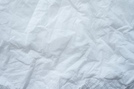 Full frame shot of crumpled tissue fabric texture and background. Tissue fabric is slightly rough and crisp in texture.の写真素材