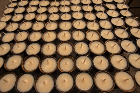 Rows of Beeswax candle in Buddhist temple in Kathmandu, Nepal. The symbolism of a lighted candle has become established in many festivals and religions.の写真素材