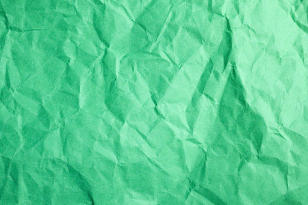 Full frame shot of crumpled green paper sheet texture and background.の写真素材