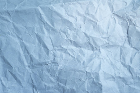 Full frame shot of crumpled light blue paper sheet texture and background.の写真素材