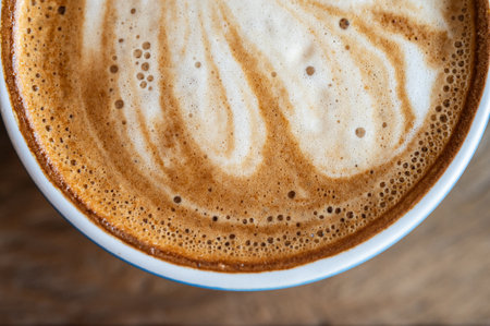 Close up of the surface of hot latte coffee. A latte is a coffee drink made with espresso and steamed milk.の写真素材