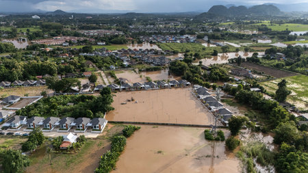 Aerial view of housing estate in suburb of Chiang Rai flooded by Kok river after typhoon Yagi has swept Southeast Asia. The storm is Asia's most powerful this year (2024).の写真素材
