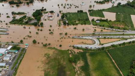 Aerial view of car driving on the road flooded during typhoon Yagi has swept Chiang Rai province of...