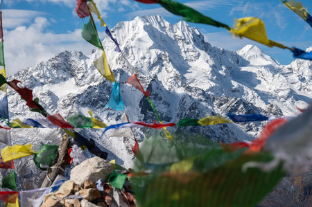 Beautiful view of Mt.Naya Kanga look through prayer flags in Langtang valley of Nepal seen from...