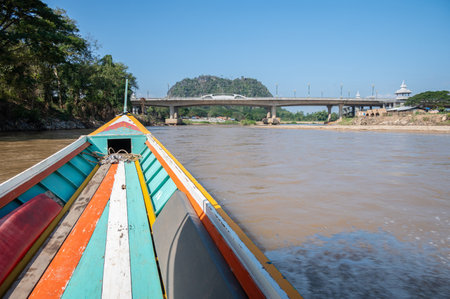 Long-tail boat perspective view while moving on Kok river the river that runs through the city of Chiang Rai province of Thailand. The river originates in the Shan State of Burma.の写真素材