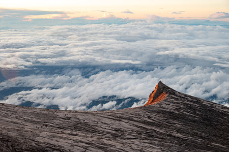 Spectacular view of an iconic South peak (3,900 m) on Mt.Kinabalu lit by sunlight. Mt Kinabalu is one of the highest mountain in South East Asia.の写真素材