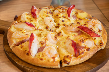 A seafood deluxe pizza serving on table. Pizza is a favorite food for many around the world.の写真素材
