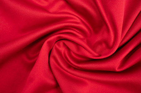 Full frame shot of wrinkled red polyester cloth texture and background.の写真素材