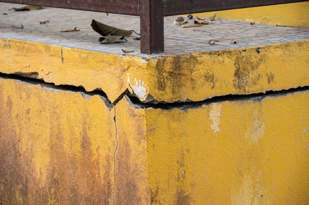 Cropped shot view of cracked building. Wider cracks often represent serious structural damage and...