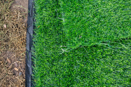 An incomplete green artificial turf used for covering sport arena or garden. Artificial grass are made by polyethylene or nylon, convenient and it does not require much maintenanceの写真素材