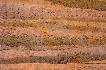 Full frame shot of an earthen wall texture of clay house structure. These walls are constructed by...