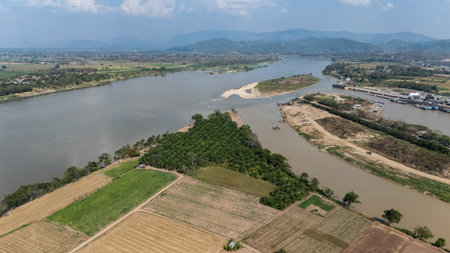 Aerial view of "Sob Kok" ,confluence of Kok river and Mekong Rivers in the Ban Saeo Sub-district, within Chiang Sean District, in Chiang Rai Province, Thailand.の写真素材