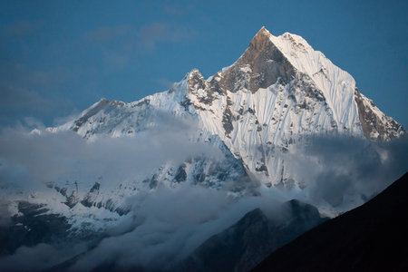 Mt.Machapuchare (Mt.fish tail) the holy mountain in Annapurna region in Nepal after sunset seen from Annapurna base camp, Nepal.の写真素材