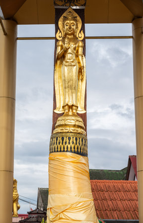 Standing Buddha made by wood carving style from Hopea odorata tree situated at Wat Pa Kluay temple in Chiang Rai province of Thailand.の写真素材