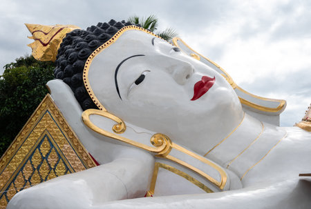 Biggest reclining Buddha situated in Wat Chetawan temple in the downtown of Chiang Rai province of Thailand.の写真素材