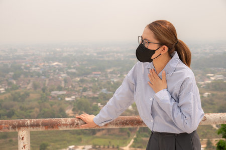 Businesswoman having respiratory allergy caused of by Bad air pollution (PM2.5). PM2.5 levels meaning the air quality posed a health hazard.の写真素材