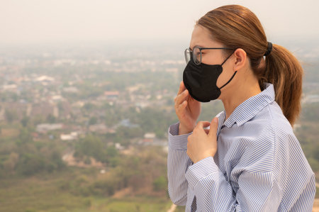 Asian businesswoman coughing becaused of allergy from Bad air pollution (PM2.5).の写真素材