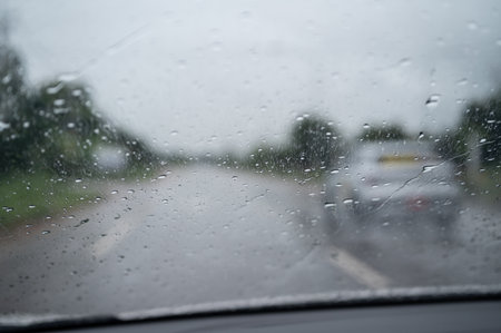Rain drop on the car glass window while driving on the road.の写真素材