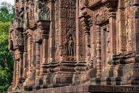 Beautiful bas relief in Banteay Srei a 10th century Cambodian temple dedicated to the Hindu god Shiva made by pink and red sandstone in Siem Reap, Cambodia.の写真素材