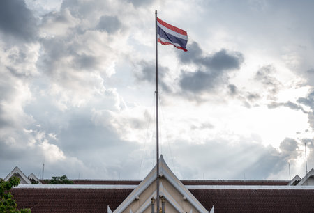 A Thailand national flag on Uttaradit city ââhall blowing by wind.の写真素材