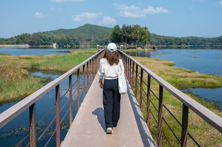 Rear view of tourist while visiting Mae Puem National Park in Phayao province of Thailand. Mae Puem National Park covers an area of 222,500 rai in Chiang Rai and Phayao Provinces.の写真素材