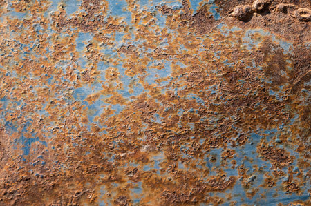 An old rusty metal sheet roof textured. Rust is an iron oxide formed by the reaction of iron and oxygen in the catalytic presence of water or air moisture.の写真素材