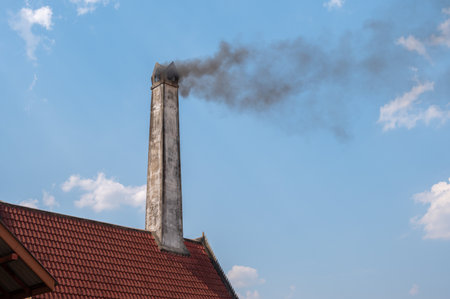 Smoke from a crematorium chimney. Crematory or cremation center is a venue for the cremation of the dead.の写真素材