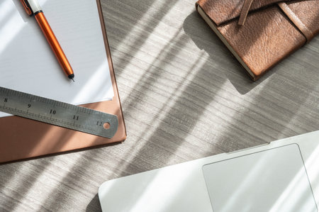 Table view of office table desk with notebook, computer, paper, pen, ruler etc. the accessories for office work.の写真素材
