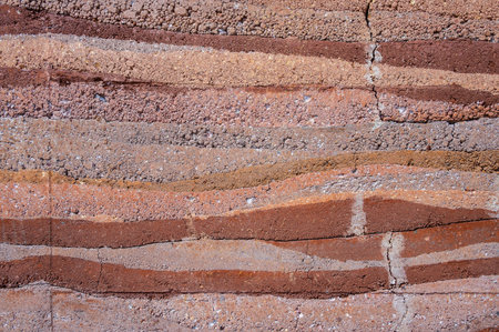 Full frame shot of an earthen wall texture of clay house structure. These walls are constructed by ramming a mixture of aggregates, including gravel, sand, silt and a small amountの写真素材