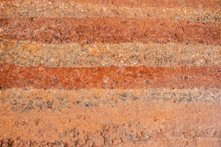 Full frame shot of an earthen wall texture of clay house structure. These walls are constructed by ramming a mixture of aggregates, including gravel, sand, silt and a small amountの写真素材
