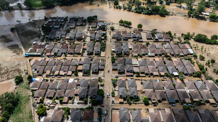 Aerial view of housing estate in suburb of Chiang Rai province flooded by Kok river rising after heavy rain. Chiang Rai hit by flash floods and runoff after overnight rain.の写真素材