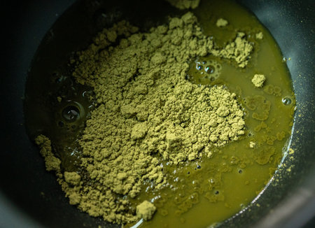 Matcha powder with warm water before blend for make Matcha tea. The green tea powder is whisked into hot water, instead of steeped, to form a frothy drink.の写真素材