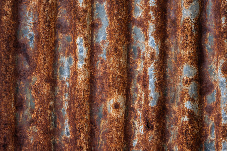 An old rusty metal sheet roof textured. Rust is an iron oxide formed by the reaction of iron and...