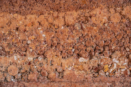Full frame shot of rough earthen wall texture. These walls are constructed by ramming a mixture of aggregates, including gravel, sand, silt and a small amount of clay.の写真素材
