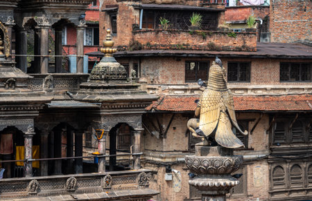 Rear view of the Garuda statue sitting on stone pillar in Patan Durbar Square, Nepal.の写真素材