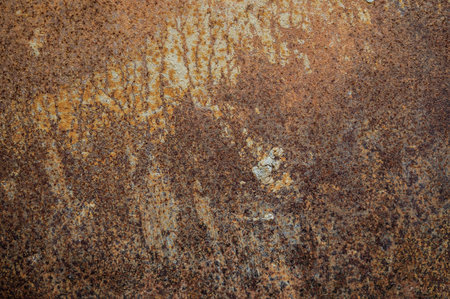 An old rusty metal sheet roof textured. Rust is an iron oxide formed by the reaction of iron and...