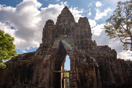 The face tower on the south gate to Angkor Thom the ancient capital city of Khmer empire in Siem Reap, Cambodia.の写真素材